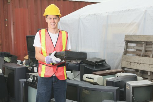 Waste removal truck collecting household waste